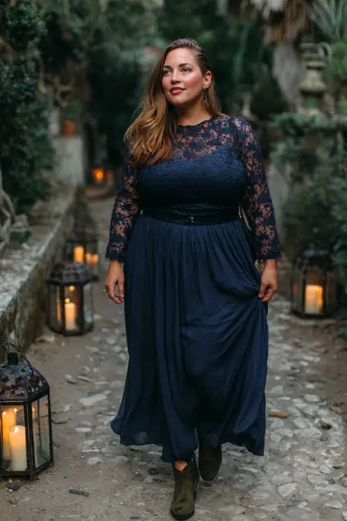 A plus size woman wears a navy lace gown with a flowing skirt, styled with dark suede boots