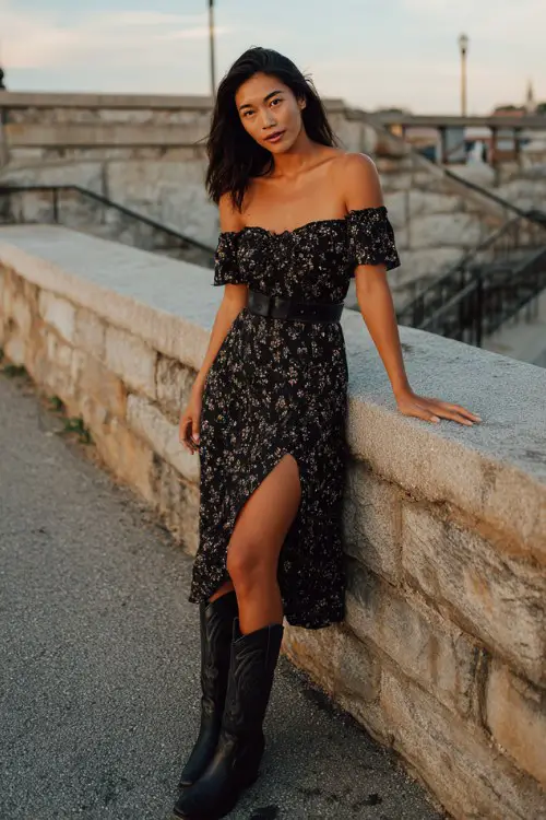woman wearing black floral off-shoulder midi dress with slit, black leather cowboy boots