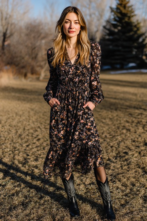 woman wearing black long sleeve floral midi dress with flowy hem, black cowboy boots, sheer tights