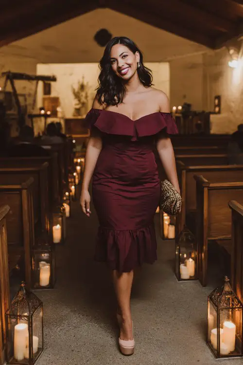 A curvy woman wears a deep wine-colored off-shoulder midi dress with tiered lace ruffles and blush platform heels