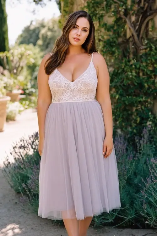 A plus-size woman wears a lavender tulle midi dress with delicate lace bodice and airy skirt movement, paired with block heels