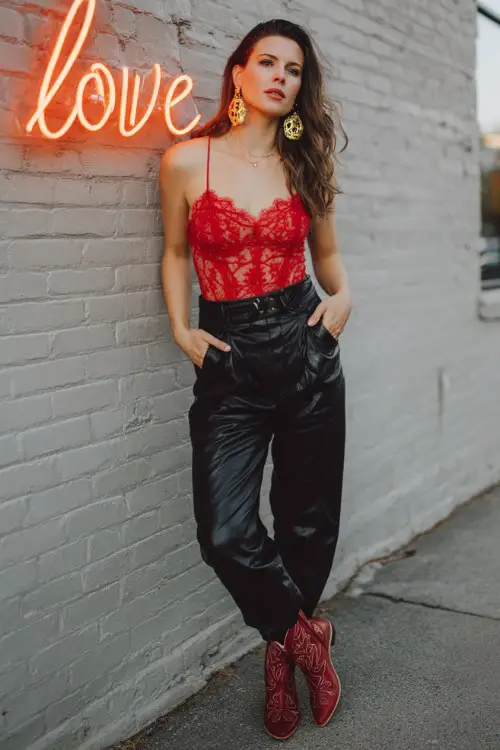 A romantic outfit featuring a woman in a red lace bodysuit and black leather pants with red cowboy boots