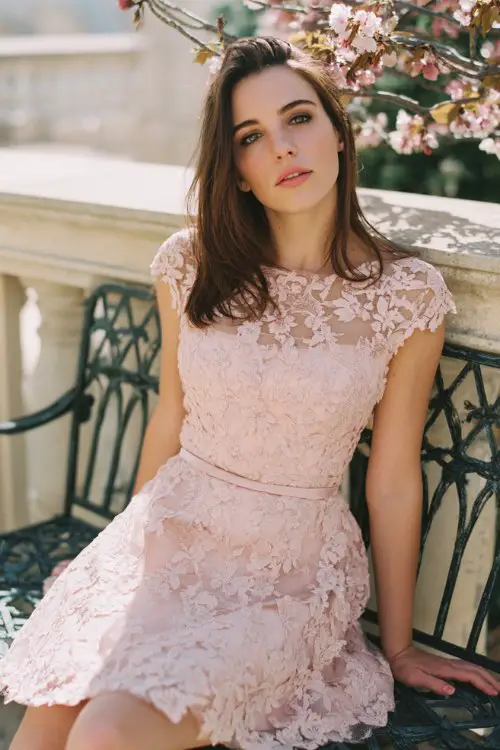 Romantic wedding guest outfit, blush pink lace mini dress with cap sleeves and delicate floral embroidery, fitted bodice with flared skirt