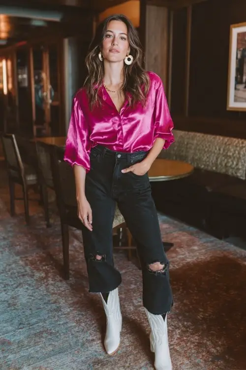 a woman wears a white cowboy boots outfit with a hot pink blouse and crop jeans for night out
