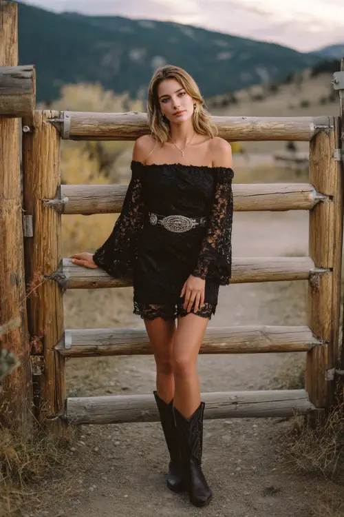 A woman wears an off-the-shoulder black lace dress with bell sleeves and a silver Western belt, paired with black cowboy boots