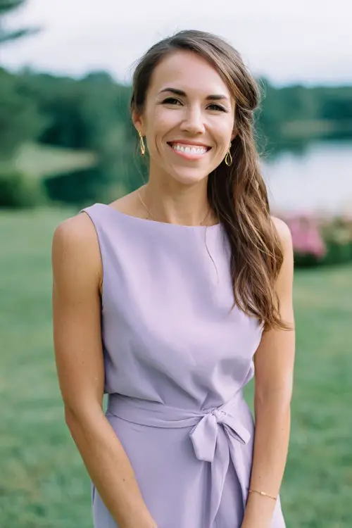 Petite woman in casual classy lilac spring wedding guest dress, tea-length, simple waist tie, outdoor wedding reception