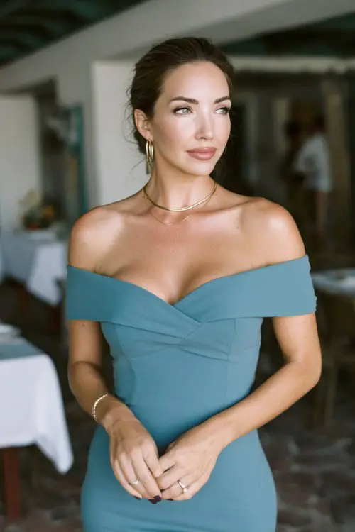 Woman over 30 in muted teal off-shoulder dress, sleek silhouette, minimalist jewelry, upscale wedding reception setting