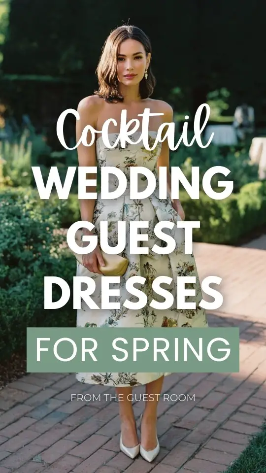 A woman wears a classy cocktail spring wedding guest dress with embroidered botanical patterns, kitten heels, and a silk clutch