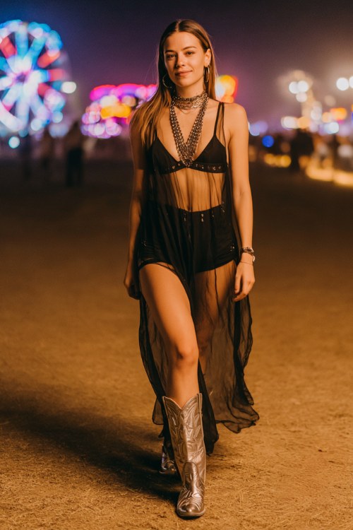 Woman wearing a sheer black mesh maxi dress over a bralette and mini shorts, metallic cowboy boots