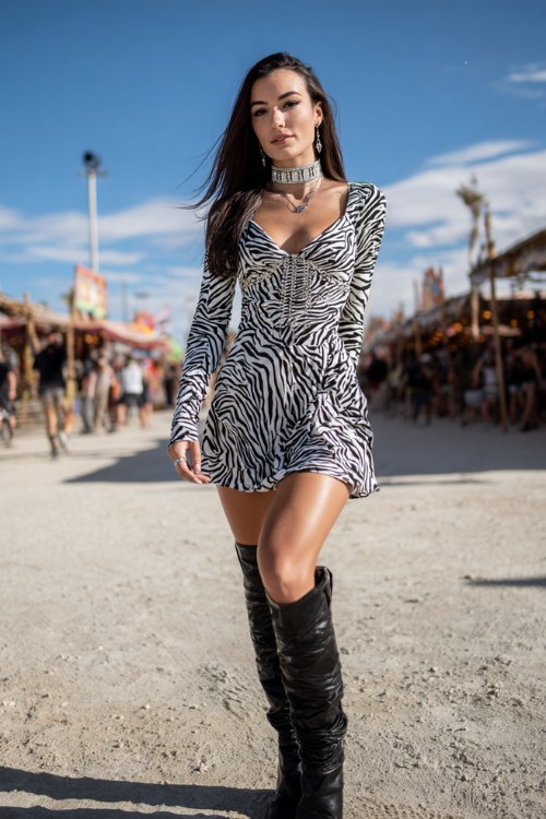 a woman wears a long-sleeve zebra print mini dress with a fitted waist and slightly flared skirt, paired with sleek black knee-high heeled boots