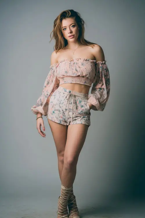 A woman in a floral off-shoulder top paired with a mini skort and lace-up sandals, styled for a feminine and breezy summer bar outfit, simple studio background