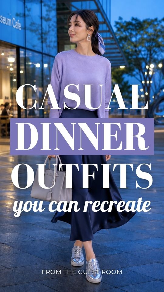 A woman wears a casual date night outfit with a lavender long-sleeve top with a flowing navy satin skirt, silver sneakers