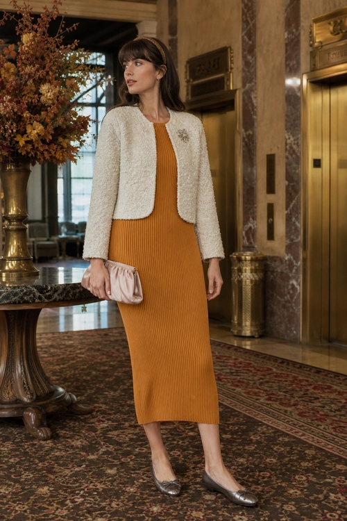 Mustard Ribbed Dress with Bouclé Jacket A mustard ribbed midi dress is styled with a cream bouclé jacket, blush clutch, headband, brooch, and metallic pointed shoes.
