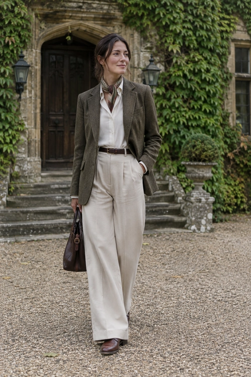 Olive Blazer and Cream Trousers An olive-brown blazer, white blouse, cream wide-leg trousers, brown belt, neck scarf, brown leather tote, and brown shoes.