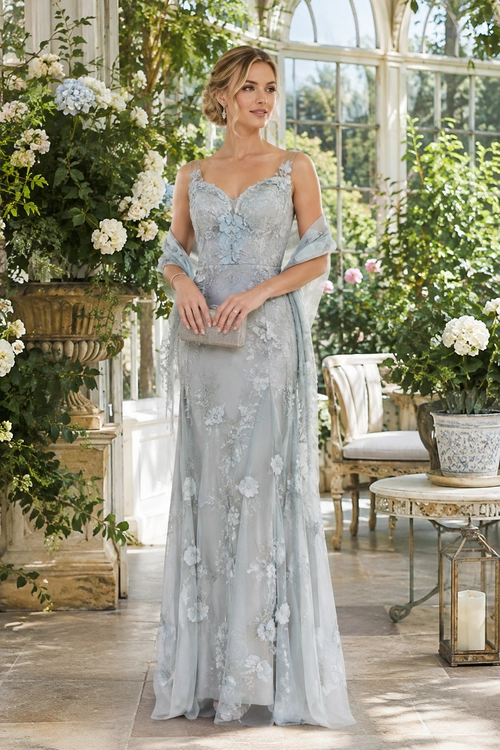 Pale Blue Floral Gown A woman wears a pale blue floral floor-length gown with a matching shawl and a small silver clutch.